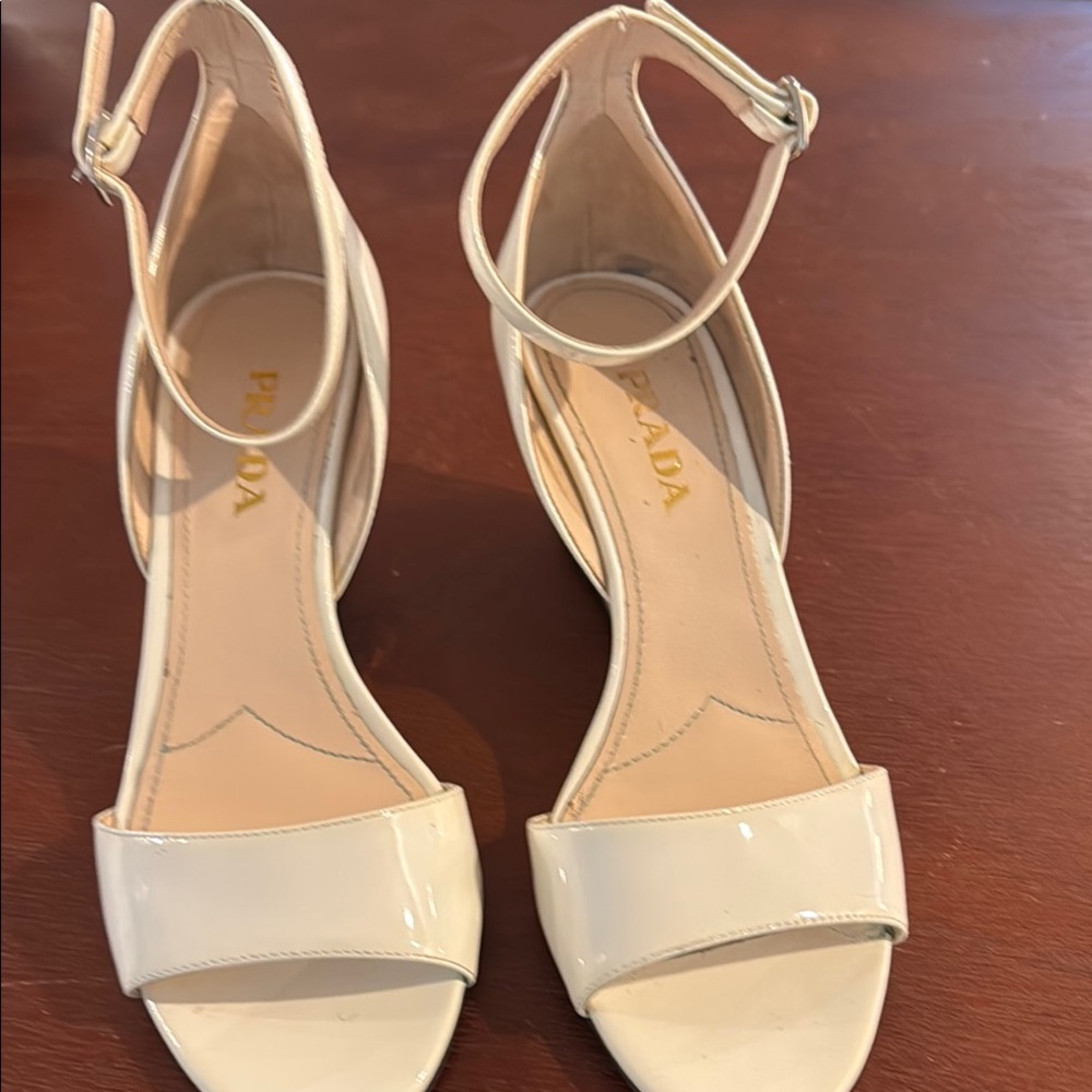 Prada white patent wedges. Slight nick on right heel, scuff on left.